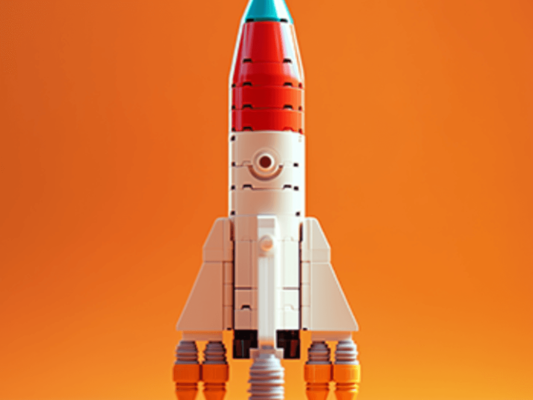 A brick-built rocket beside the photo it came from